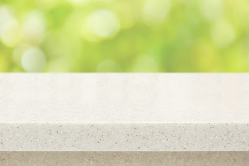 White quartz stone countertop on bokeh green background