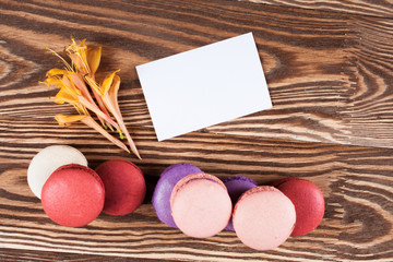 Multicolored macaroon on brown boards.