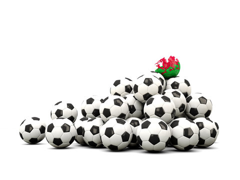 Pile of soccer balls with flag of wales