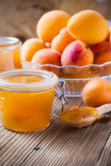 Homemade organic apricot jam in glass jar and ripe apricots