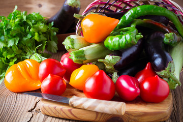 Organic vegetables in the basket on wooden table