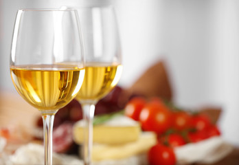 Glasses of wine with food on table closeup