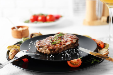 Delicious grilled steak with vegetables on plate