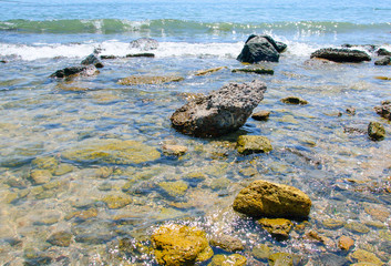 Fototapeta na wymiar clear sea water through which one can see the stones
