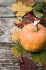 Pumpkins and fall leaves on a wooden table