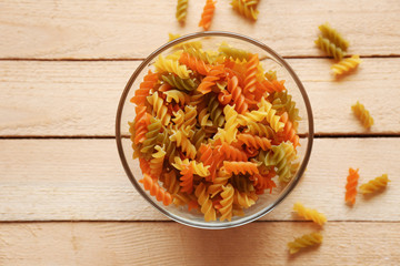 Pasta in glass bowl on wooden table