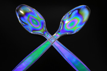 Polarized Spoons Isolated on a Black Background