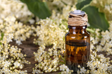 Essential oil made from elder on a rustic table