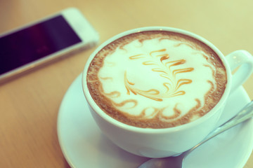 caramel macchiato coffee and mobile phone in cafe coffee