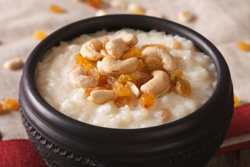 sweet rice pudding with nuts and raisins in a bowl close-up. Horizontal
