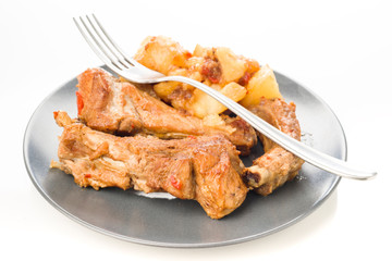 homemade stew pork ribs and potatoes with peppers on dish