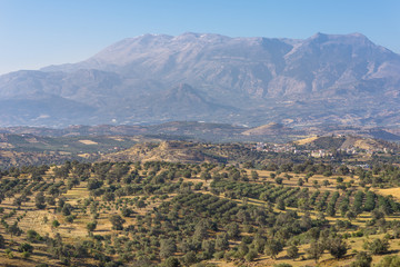 View to Sivas. Panorama landscape from south-central Crete. In the background the huge IDA Mountains with the Psiloritis as the highest elevation. In the foothills typical landscape with olive groves