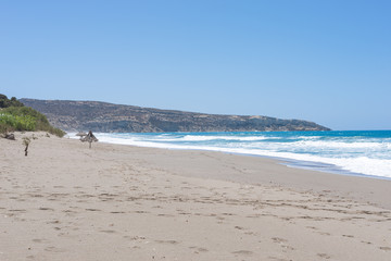 Fototapeta na wymiar Komos beach in Kalamaki situated in the south-central of Crete. The village is close to the Ida mountains, the beach is on the west side between the Messera plain and Matala in the south