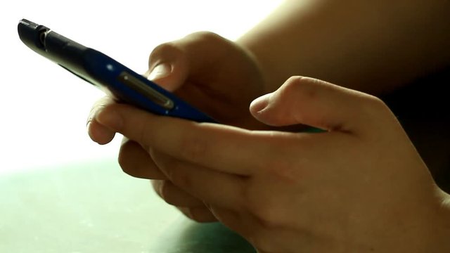 Hands typing fast text messages on smart phone 