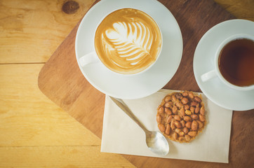 Coffee cup and tea with snack on table,topview