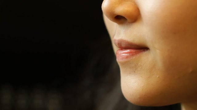 Beautiful Asian woman making quiet gesture 