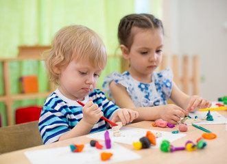 Kids or children creating arts and crafts in kindergarten