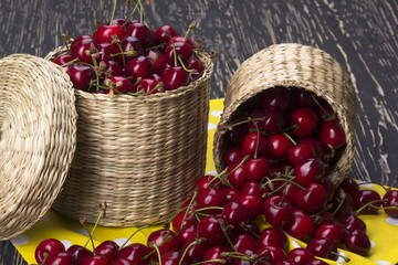 Cherry baskets on wooden background