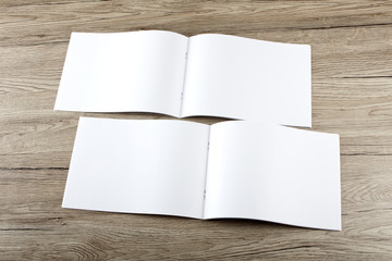 Blank catalog, brochure, magazines, book on wooden background