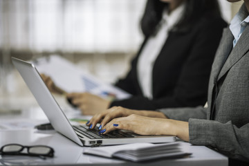 women employees typing on the laptop computer
