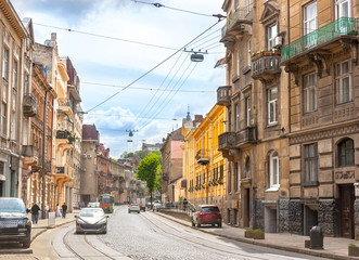 Naklejka na ściany i meble Street of the old city with large houses