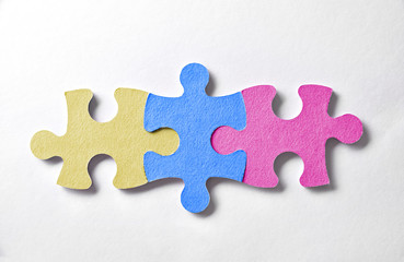 Colorful puzzle pieces aligned and bonded