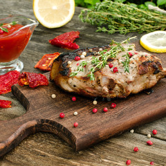 Steak from pork with thyme, lemon and tomato spicy sauce