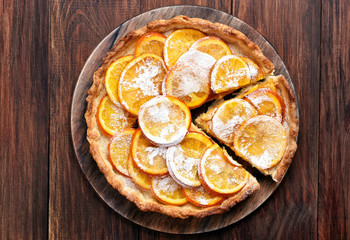 Orange tart on wooden background