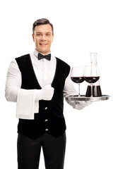 Waiter holding a tray with red wine