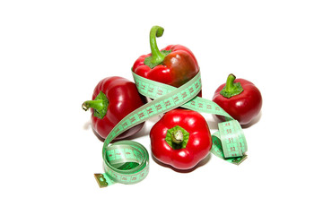 Red ripe peppers and sartorial meter on a white