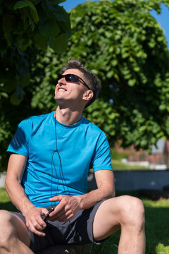 Sporty guy listening to music while training 