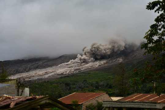 Thick smoke and ash from the volcano Sinabung is spread along the side of the mountain (Sumatra, Indonesia)