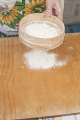 Women's hands preparing flour before baking pie