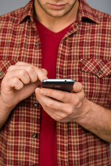 Close up photo of man's hands typing sms on phone