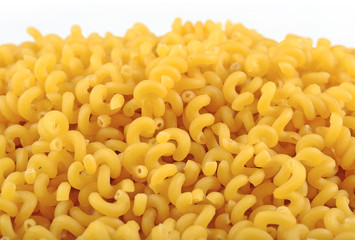 Heap of uncooked italian pasta on a white