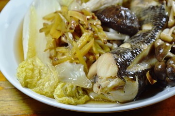 steamed snake head fish with mushroom and slice ginger on plate