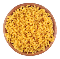 Uncooked italian pasta in a wooden bowl on a white