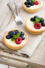 Delicious tartlets with raspberries and blueberries
on tray