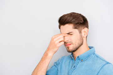 Obraz premium Handsome young overworked man thinking how to solve problems