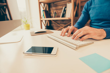 Close up photo of man's hands typing on keyboard