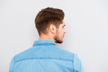 Fototapeta premium Rear view of young handsome man with bristle in blue shirt