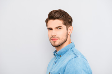 Portrait of serious young man with bristle on gray background