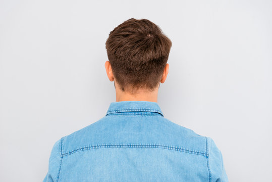 Back View Of Young Man Isolated On Gray Background