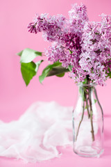 bouquet of lilac flowers on a pink background