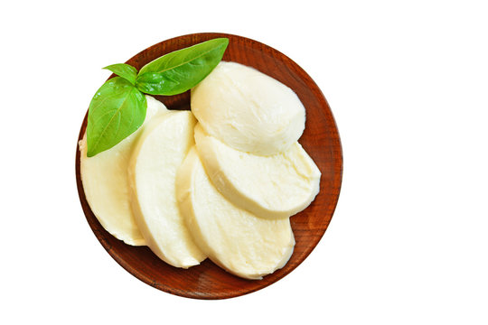 Mozzarella cheese sliced on wooden pate isolated