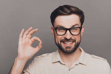 Happy smiling young man in glasses gesturing 
