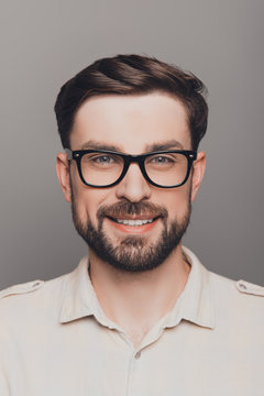 Portrait of happy smiling brainy young guy in spectacles