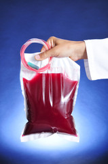 doctor man holding a blood bag