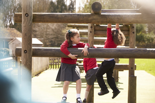 Students playing together on climbing frame during break time