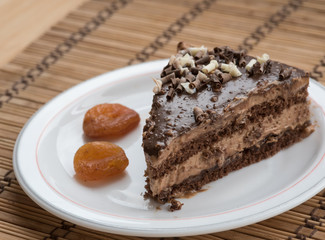 Slice of chocolate cake  garnished with nuts